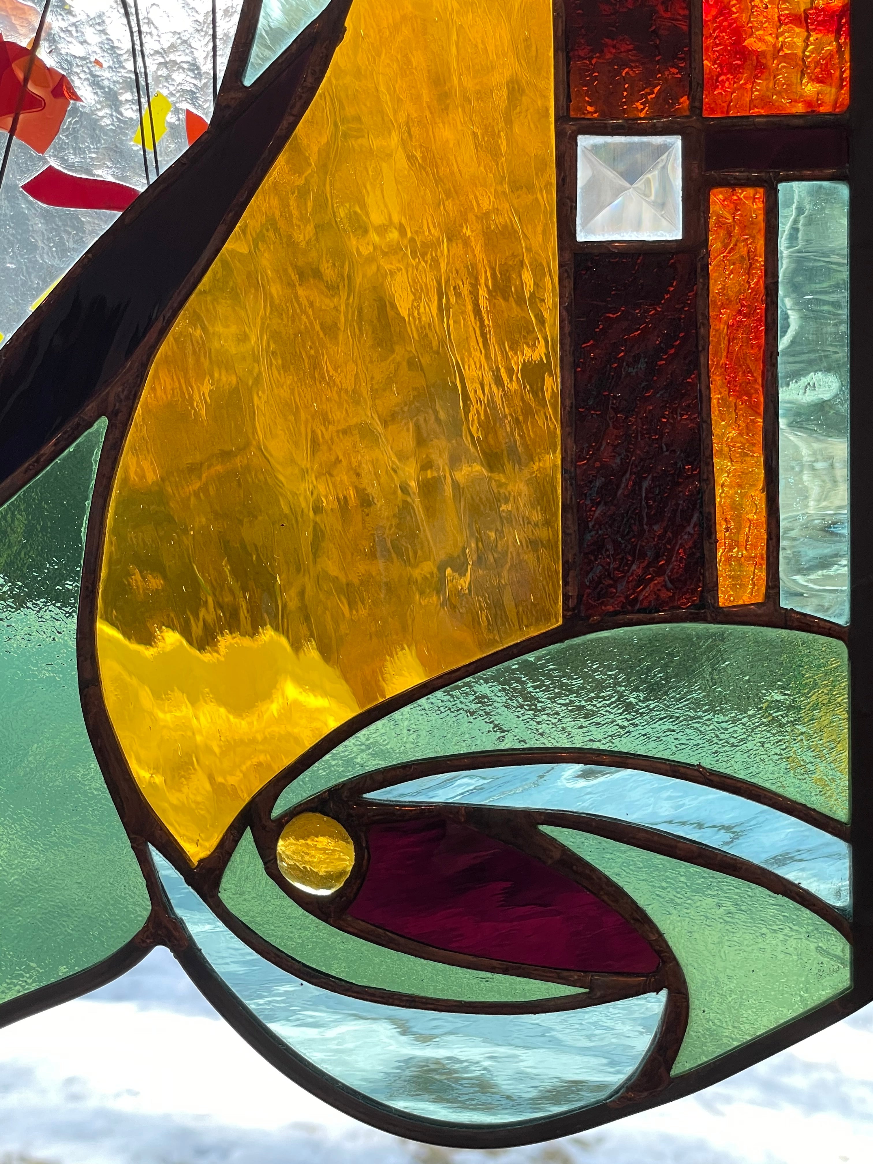 Large stained glass panel with Autumn colors and organic swirls made by Vermont artist Julia Brandis.