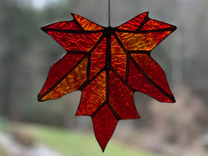 handmade stained glass maple leaf in reds and ambers