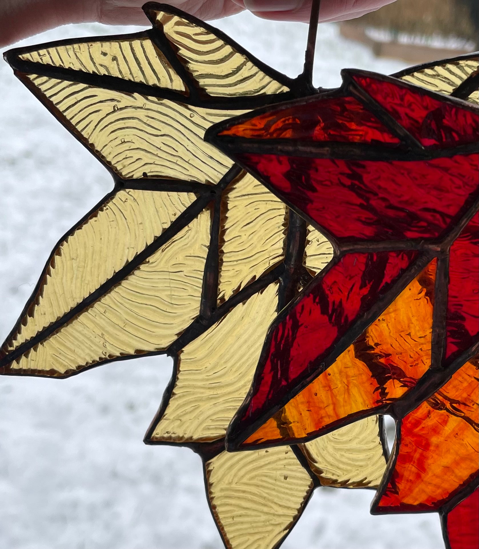 2 stained glass maple leaves in reds and golds