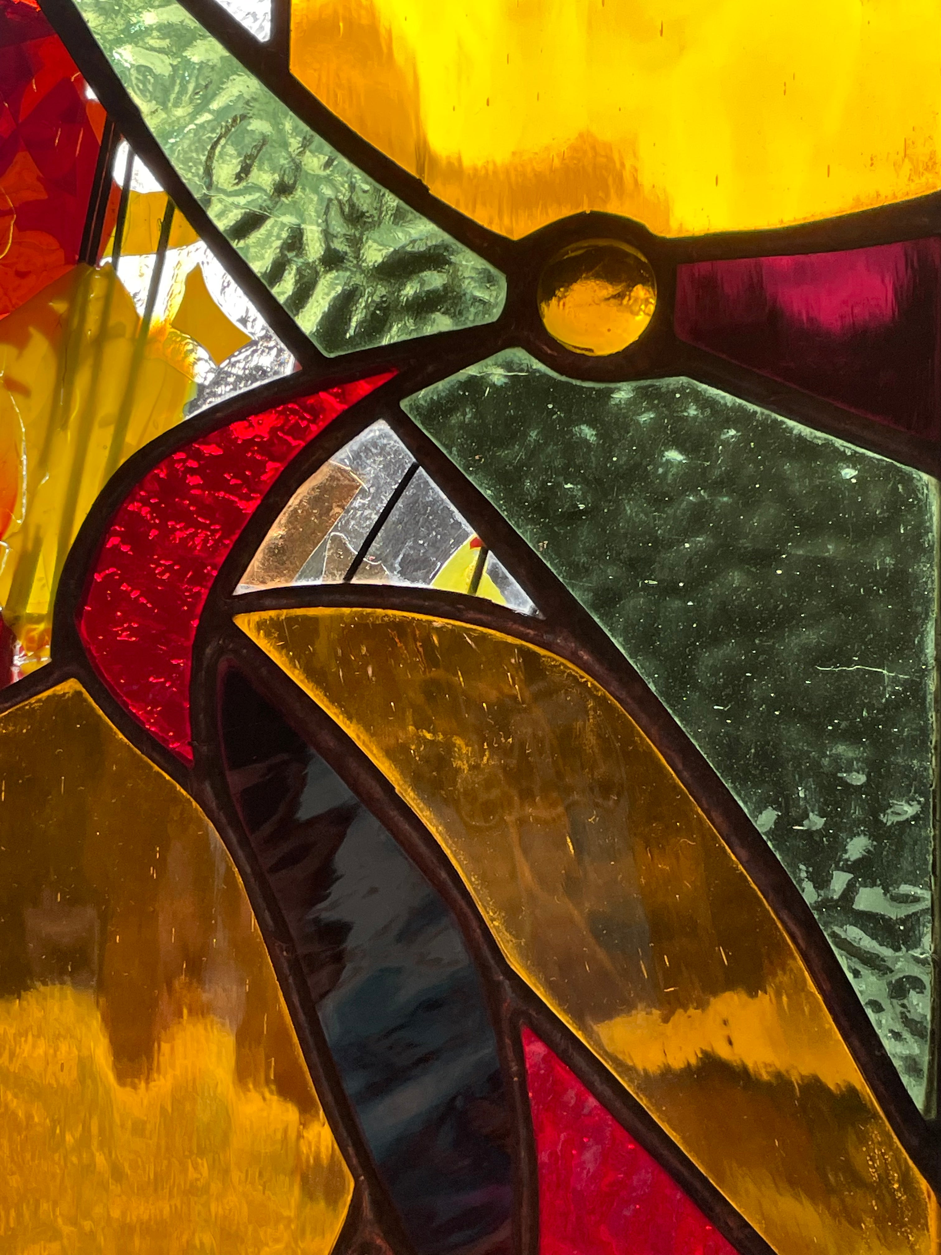 Stained glass panel made by Vermont artist Julia Brandis. An organic abstraction of autumn colors.