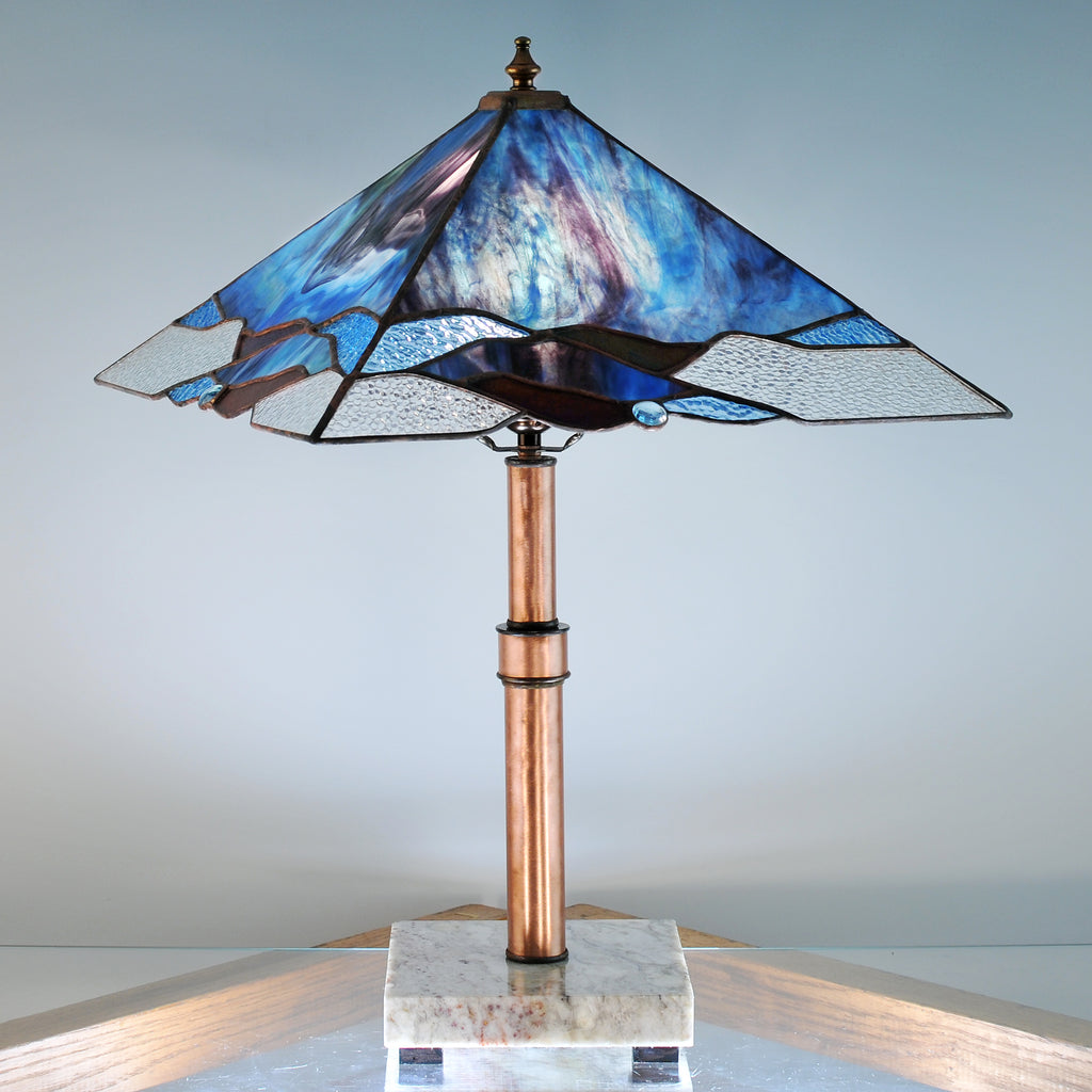 Large stained glass lamp with blue, purple, green and clear swirls made by Vermont artist Julia Brandis. Organic abstract.