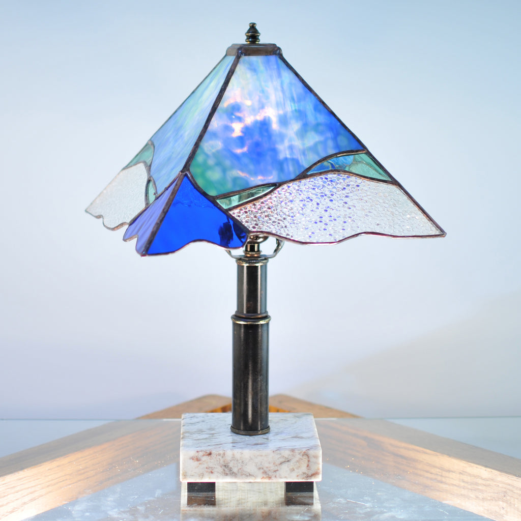 Small stained glass lamp with blue, green and clear organic swirls made by Vermont artist Julia Brandis.