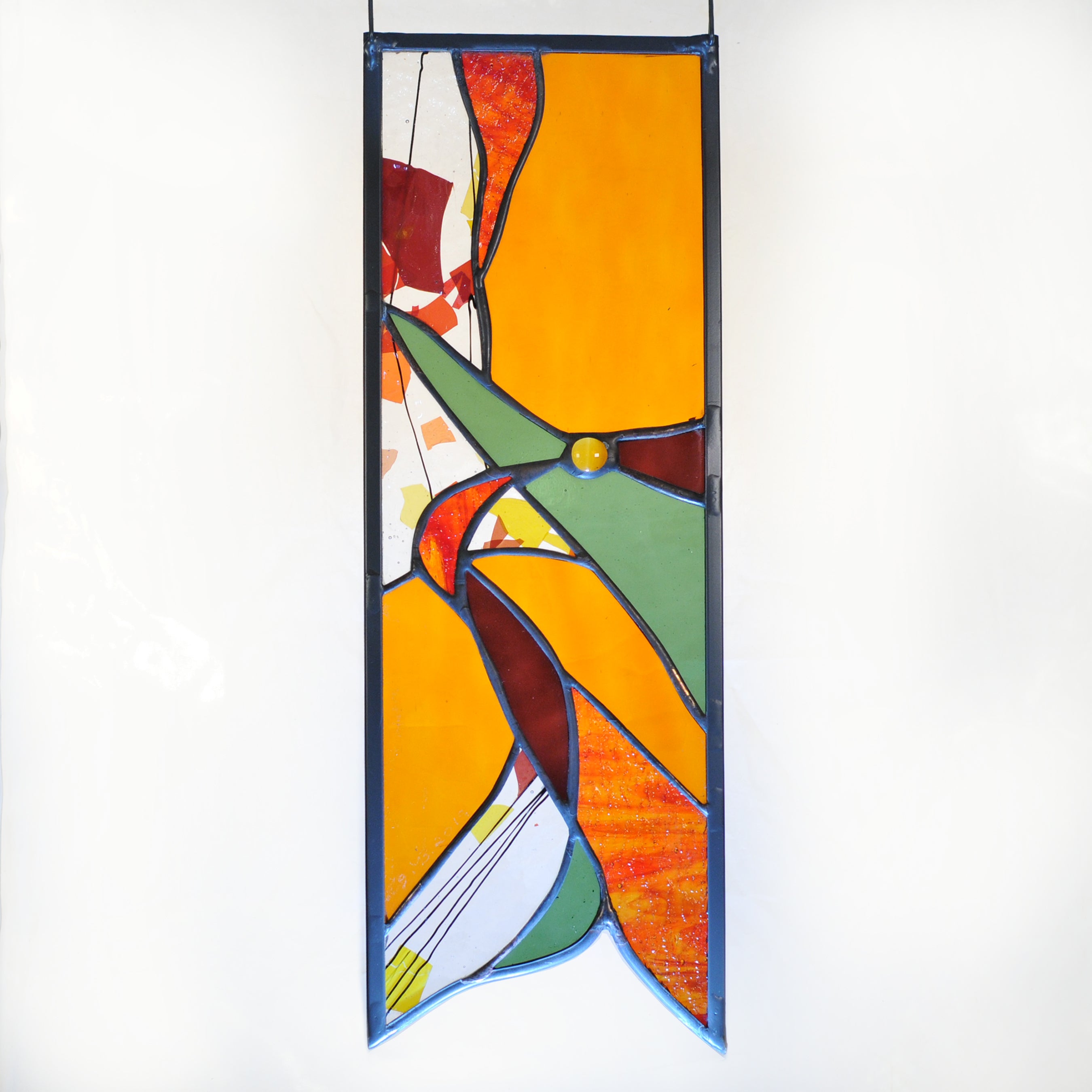 Small stained glass panel with autumn colors and organic swirls made by Vermont artist Julia Brandis.