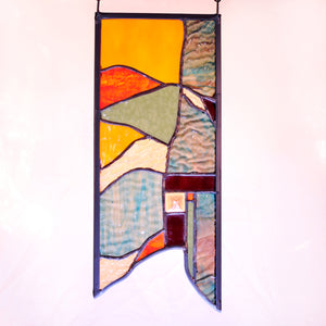 Small stained glass panel with nature inspired organic lines made by Vermont artist Julia Brandis. Organic abstract.